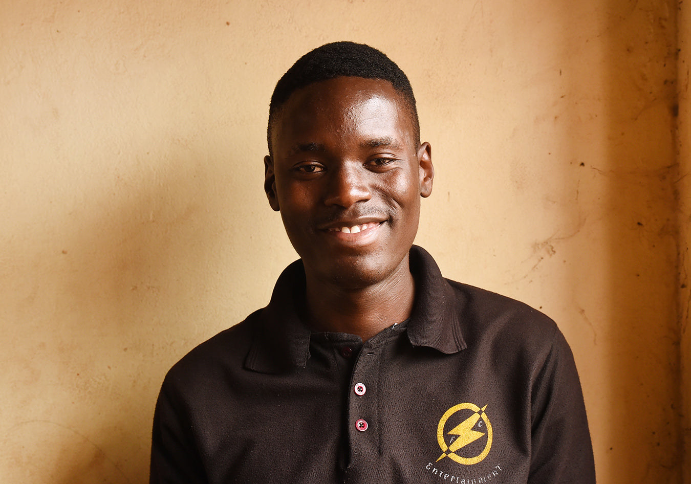 Ugandan teen smiling and wearing black shirt